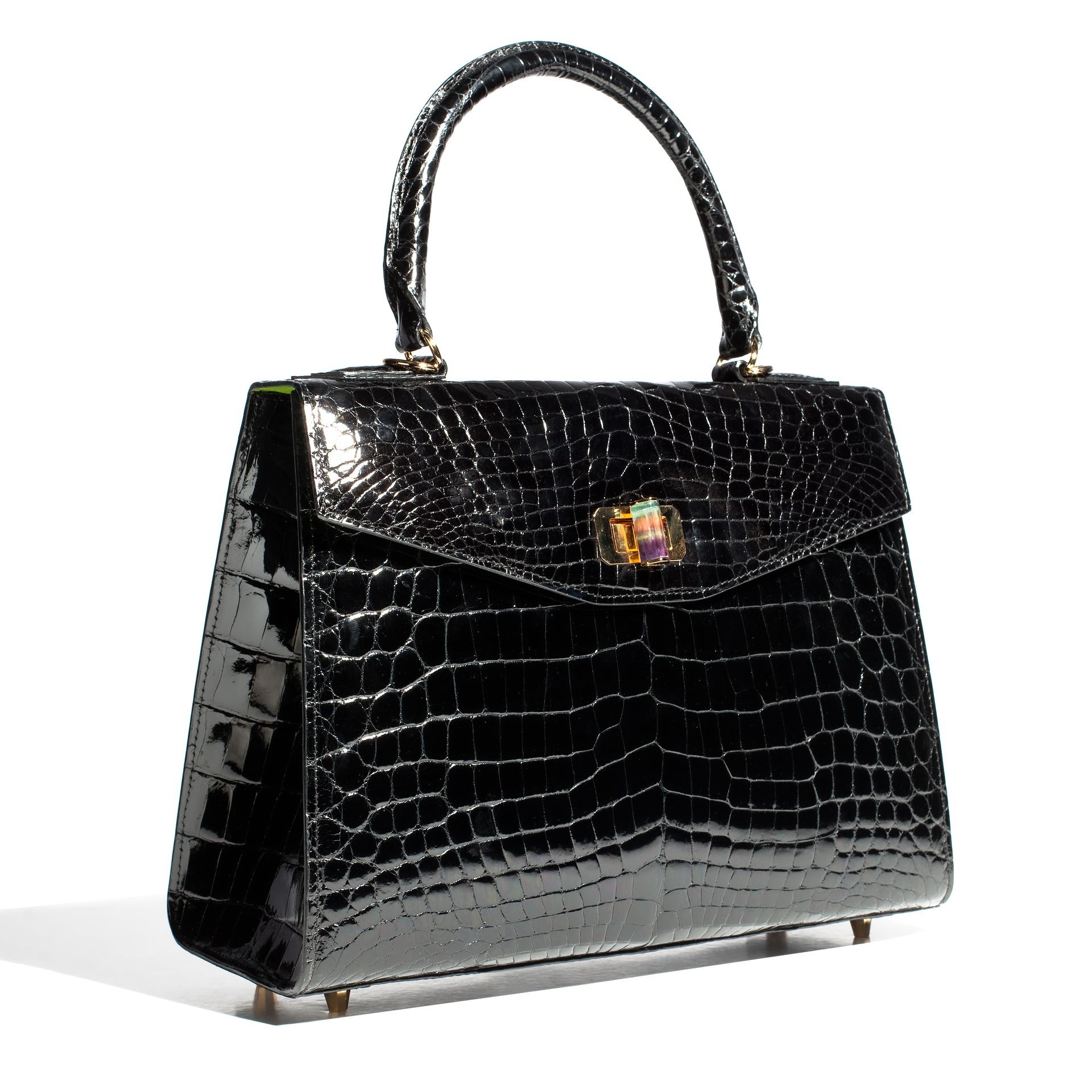 Luxury beautiful black leather crocodile black female bag on a white background
